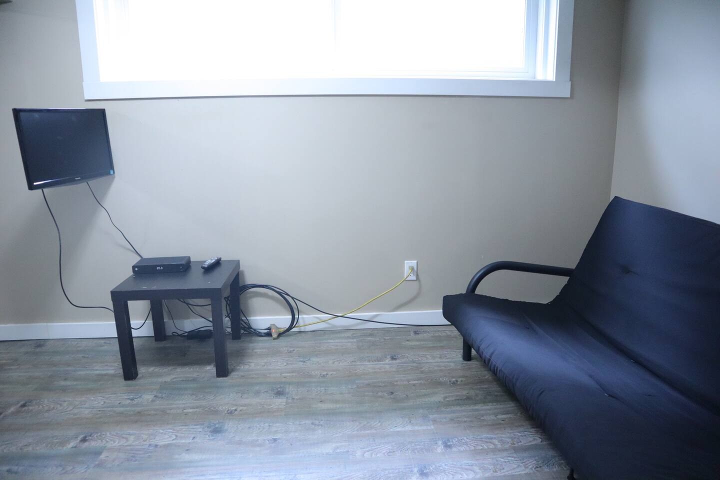 Futon seating area at the furnished basement suite